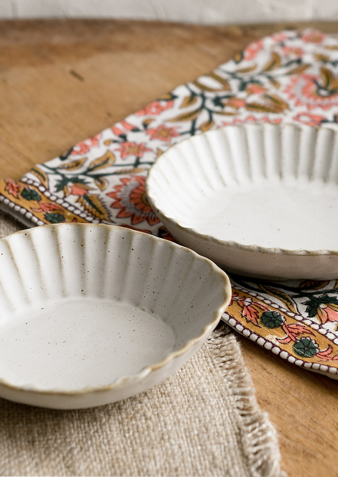Pleated stoneware dishes in assorted shapes.