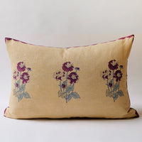 1: A lumbar throw pillow in sand color with purple flowers.