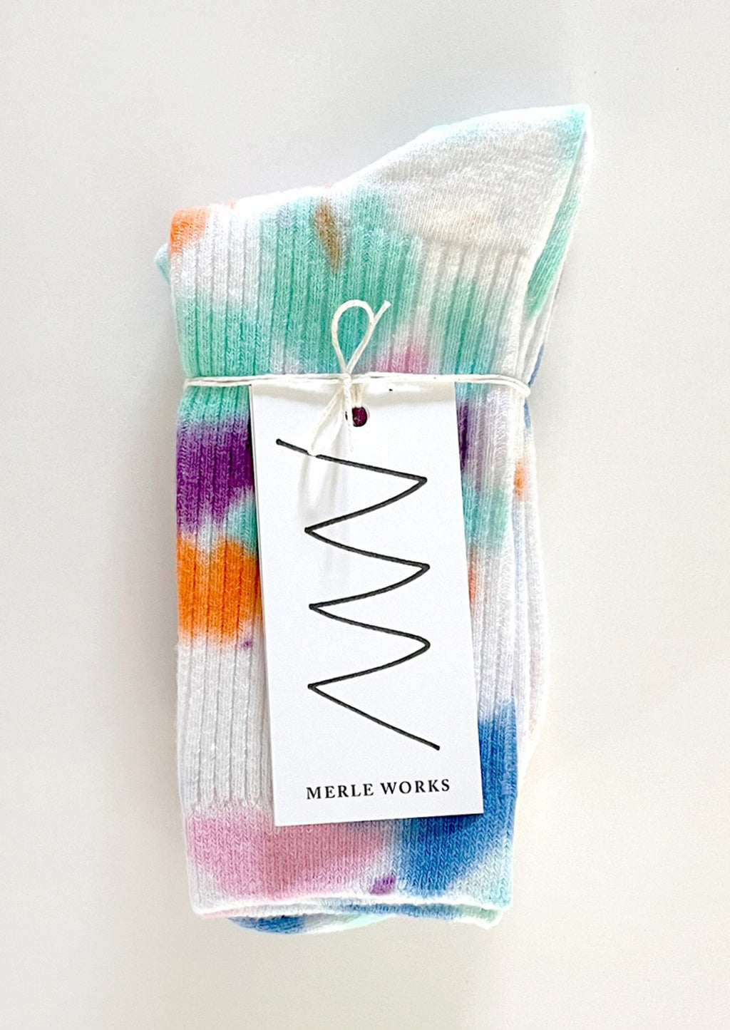 Memphis: A pair of tie dye socks in white with bright aqua, blue, orange, pink and purple.