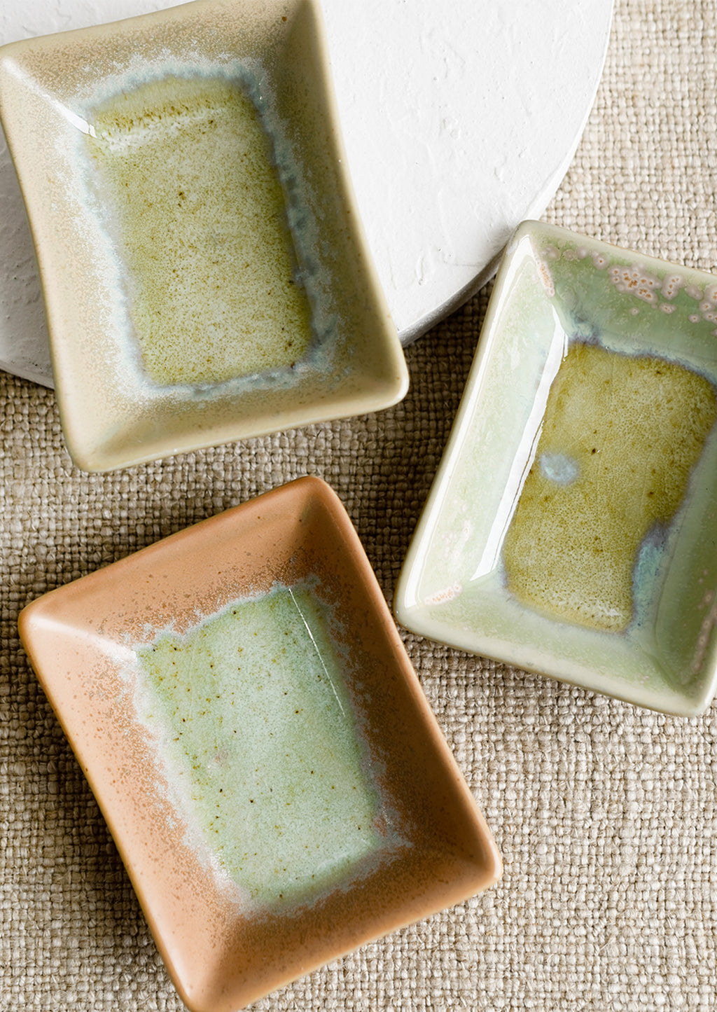 1: Rectangular ceramic sauce dishes in turquoise, green and brown varied glazes.
