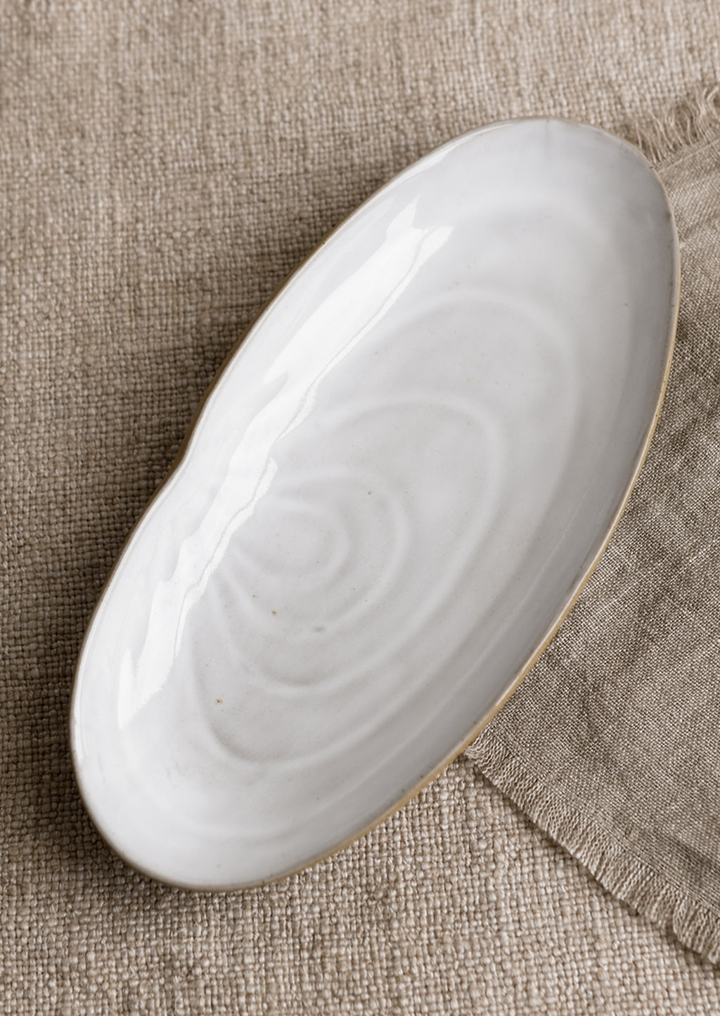 Serving Platter: A ceramic serving platter in shape of a shell.