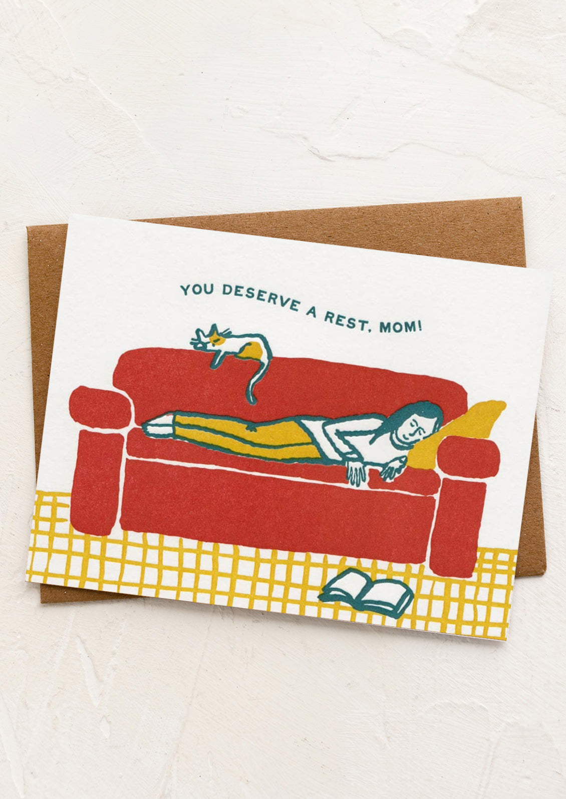 A card with illustration of woman sleeping on sofa, text reads "You deserve a rest, mom!".