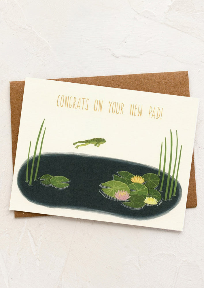 A frog and lilypad print card reading Congrats on your new pad.