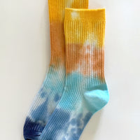 Ocean Avenue: A pair of tie dye socks in yellow, orange and blue.