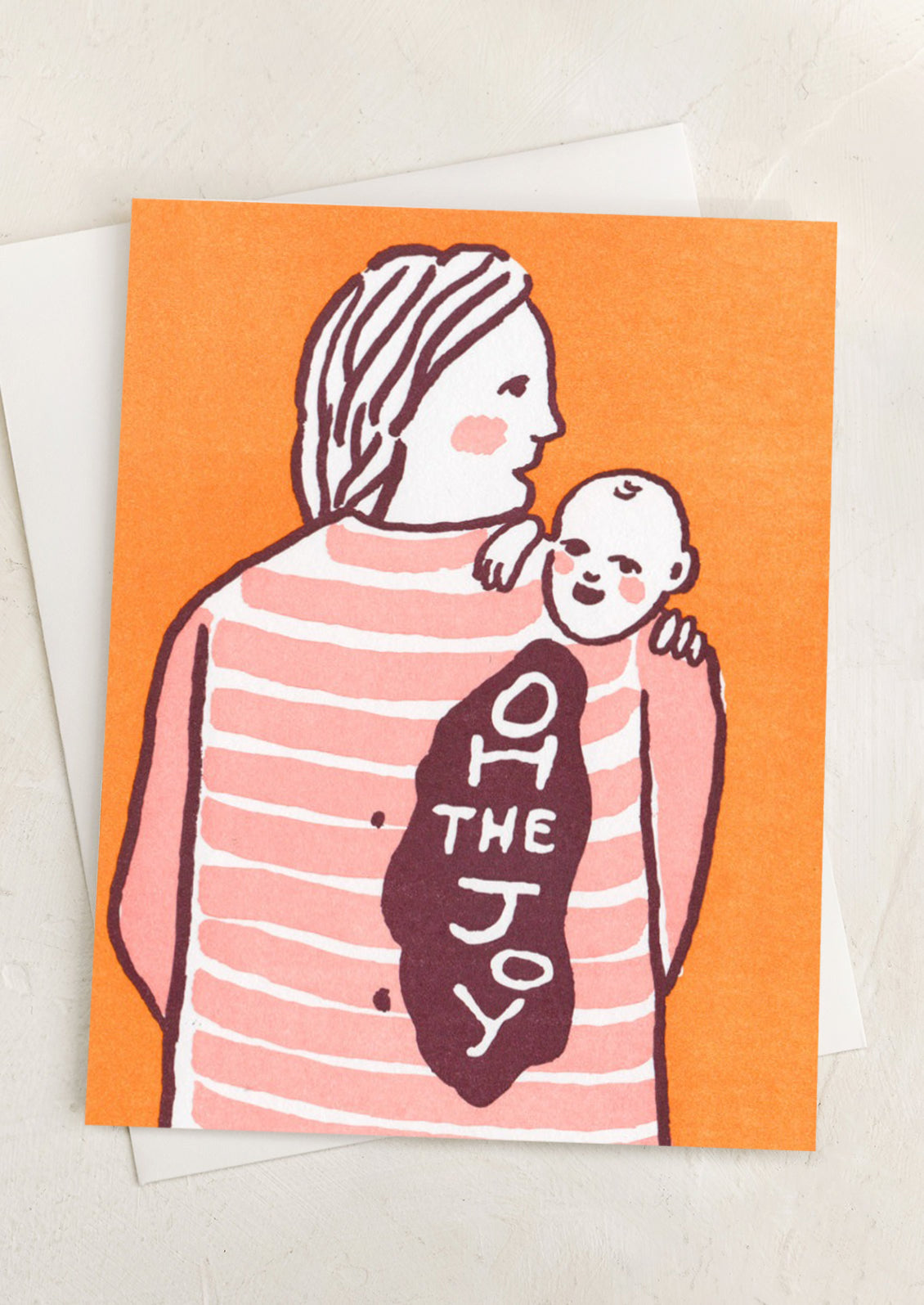 An orange card with illustration of baby throwing up over mother's shoulder, text reads "Oh the joy".
