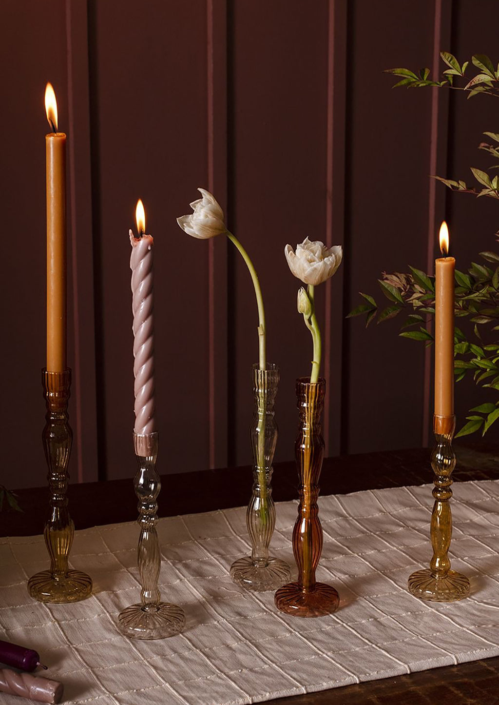 1: Assorted colors of optic glass candleholders with taper candles.