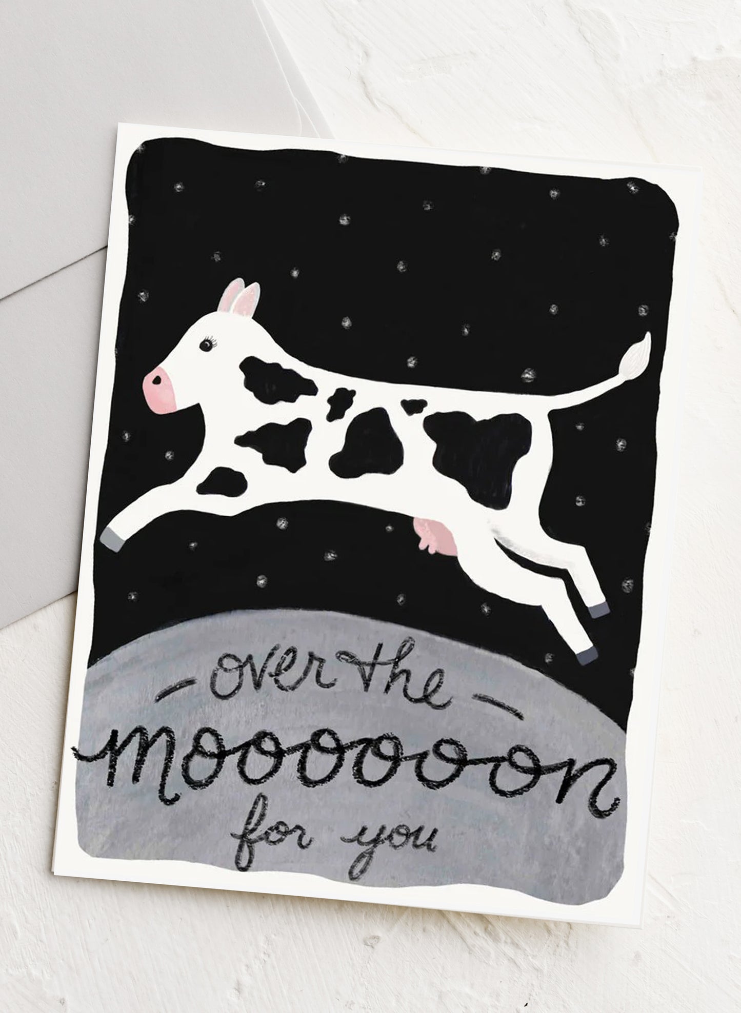 Card with a cow illustration and text 'over the moooon for you' on a white background