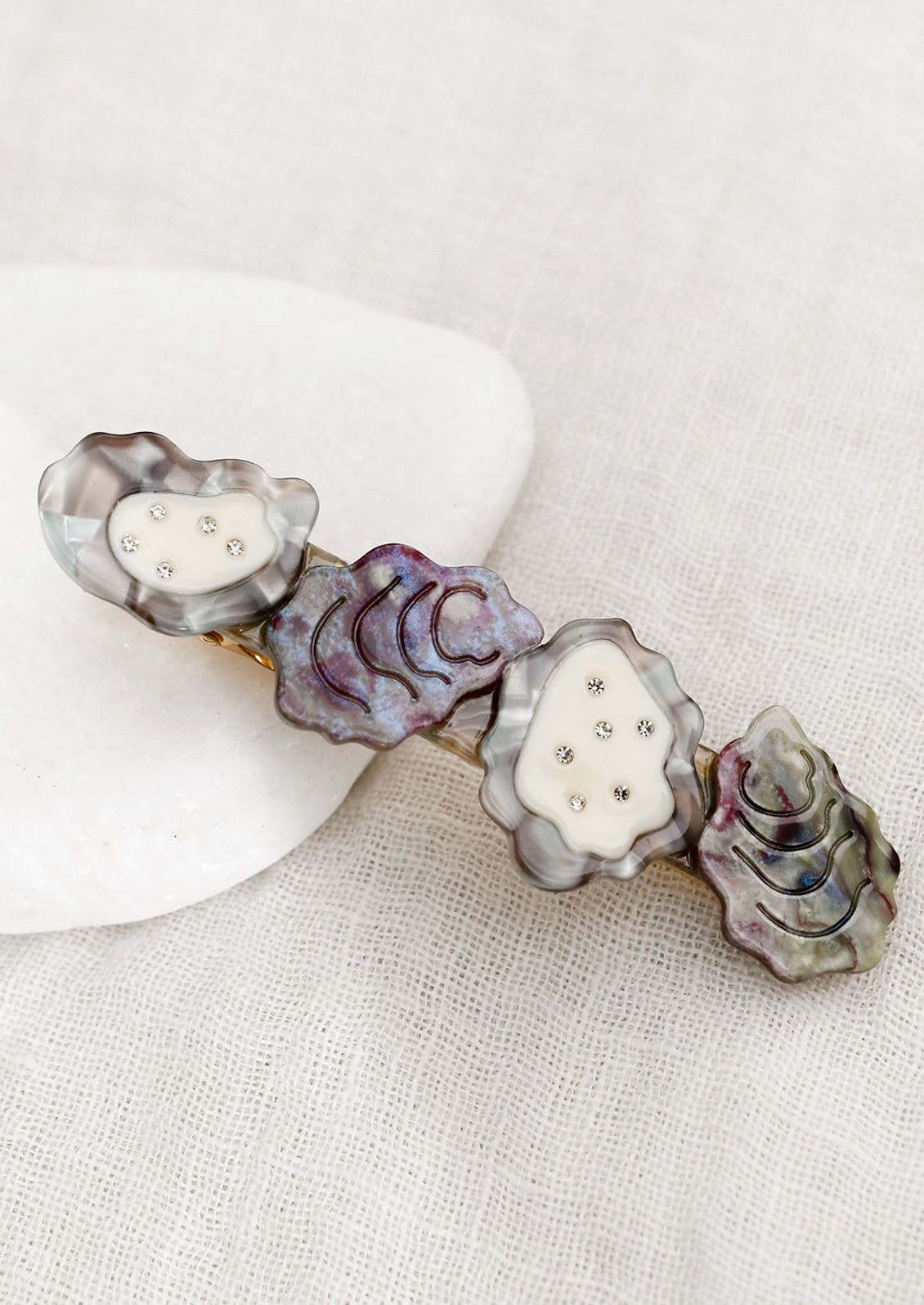 A barrette with oyster shell design.