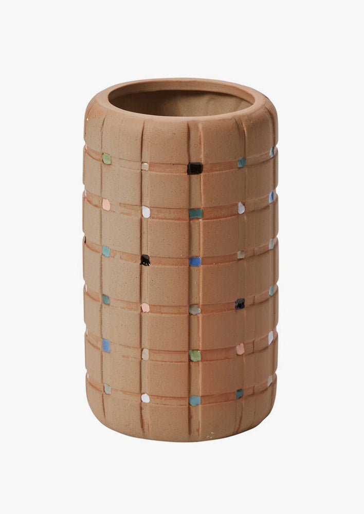 A sand colored vase with grid pattern and colorful square decoration.