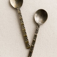 2: A brass spoon with textured handle.