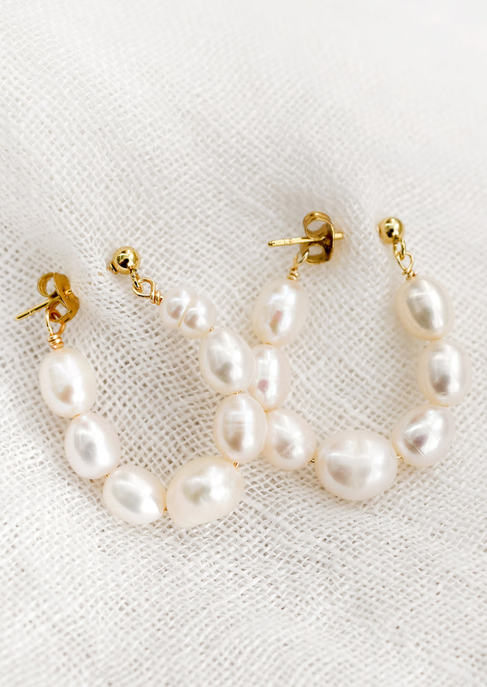 A pair of pearl loop earrings.
