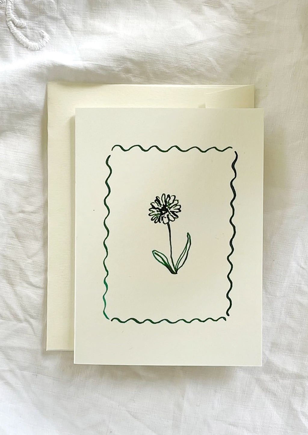 2: A card with framed floral illustration in green ink.