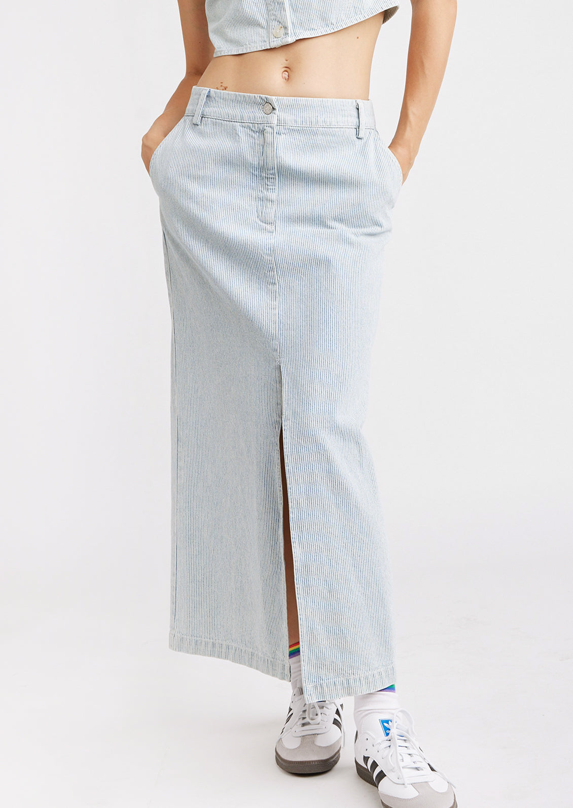 A full length pencil skirt with front slit and fine blue pinstripe pattern.