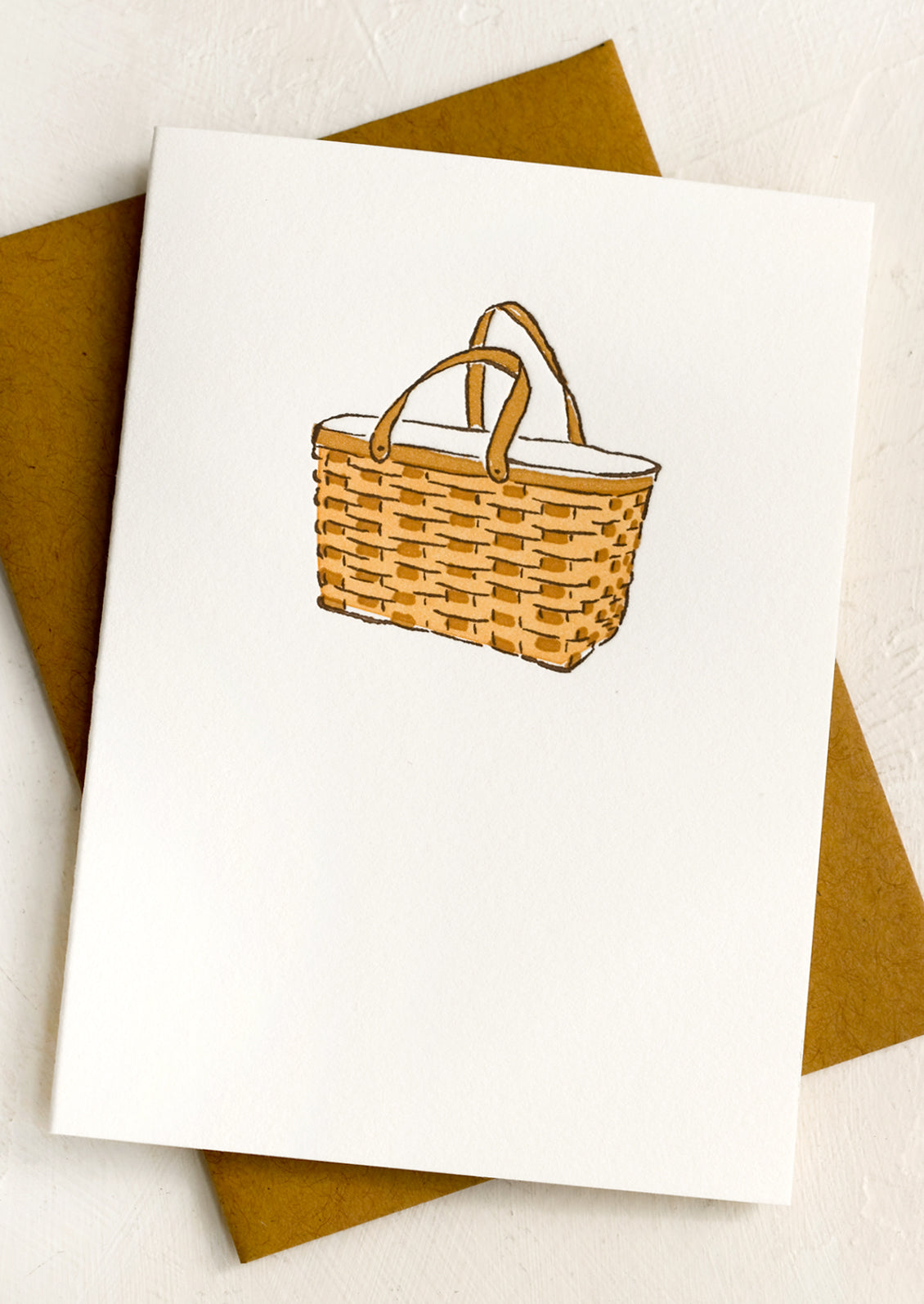 A letterpressed card with image of picnic basket.