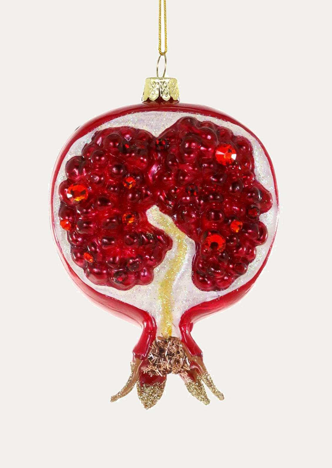 Decorative ornament shaped like a pomegranate with red seeds on a white background