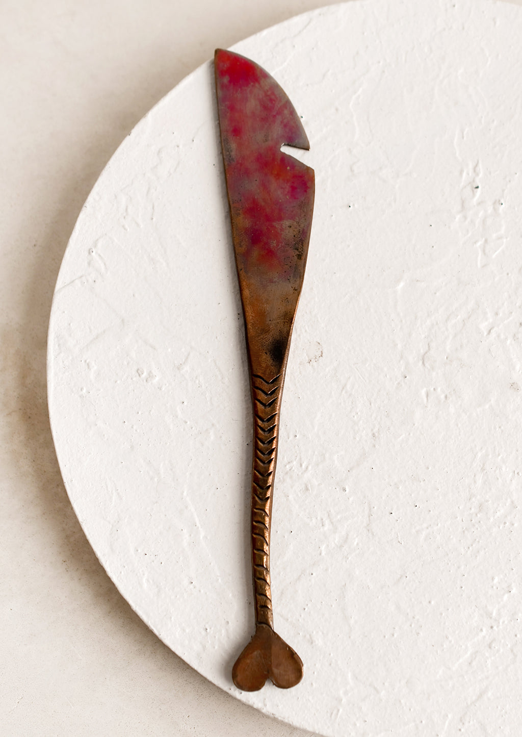 Knife: A copper knife with fish tail handle and oxidized finish.