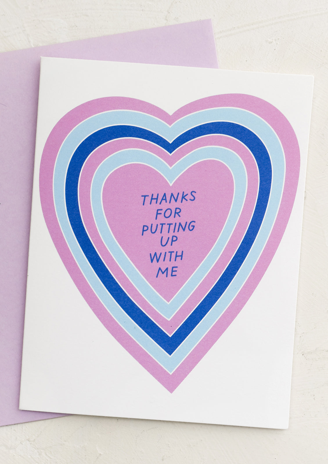 A heart print card reading "thanks for putting up with me".