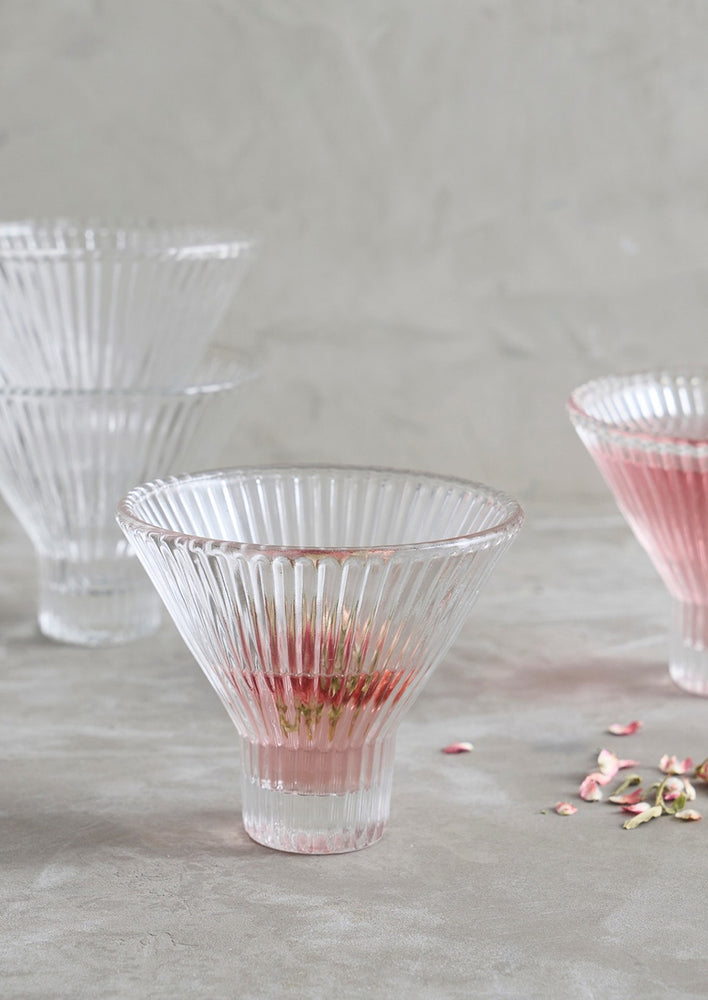1: Clear martini glasses with small footed base and ribbed texture.