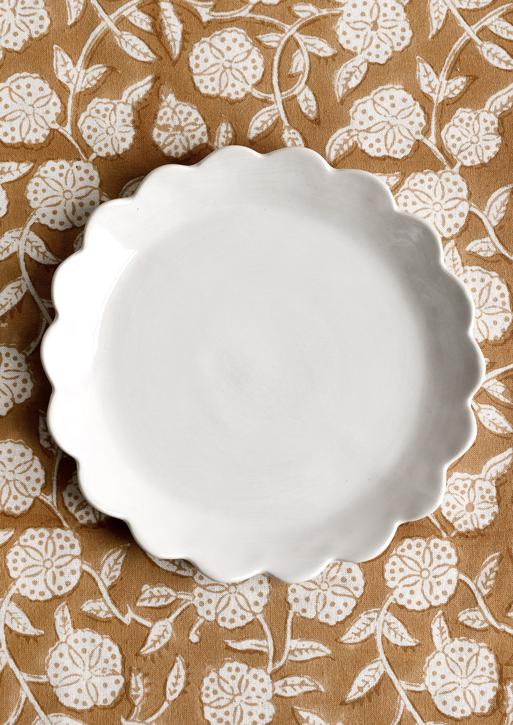 White: A scalloped ceramic dessert plate in white.