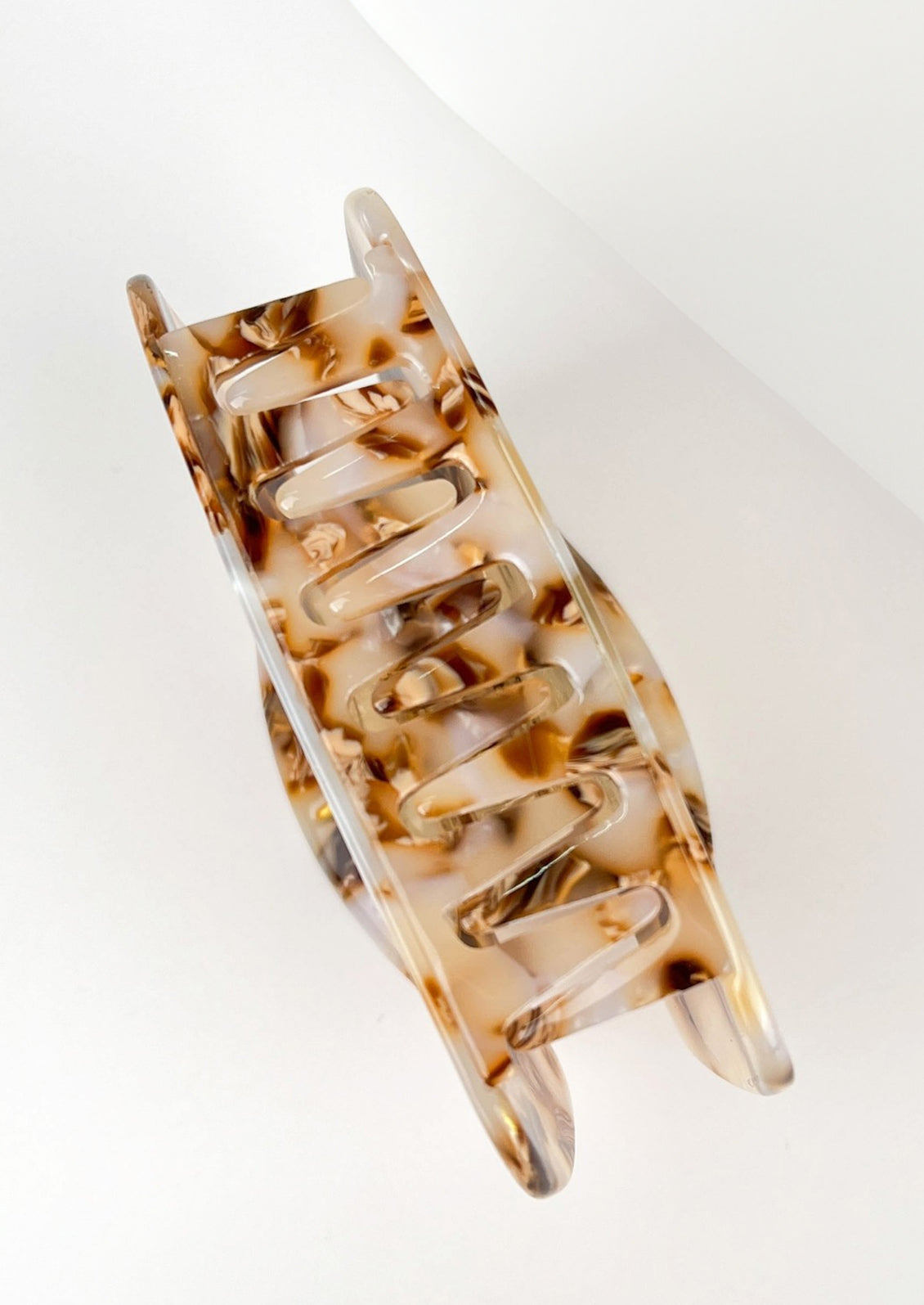 A hair claw with gold and white sun face.