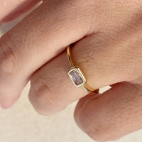 2: A gold ring with single rectangular clear stone.
