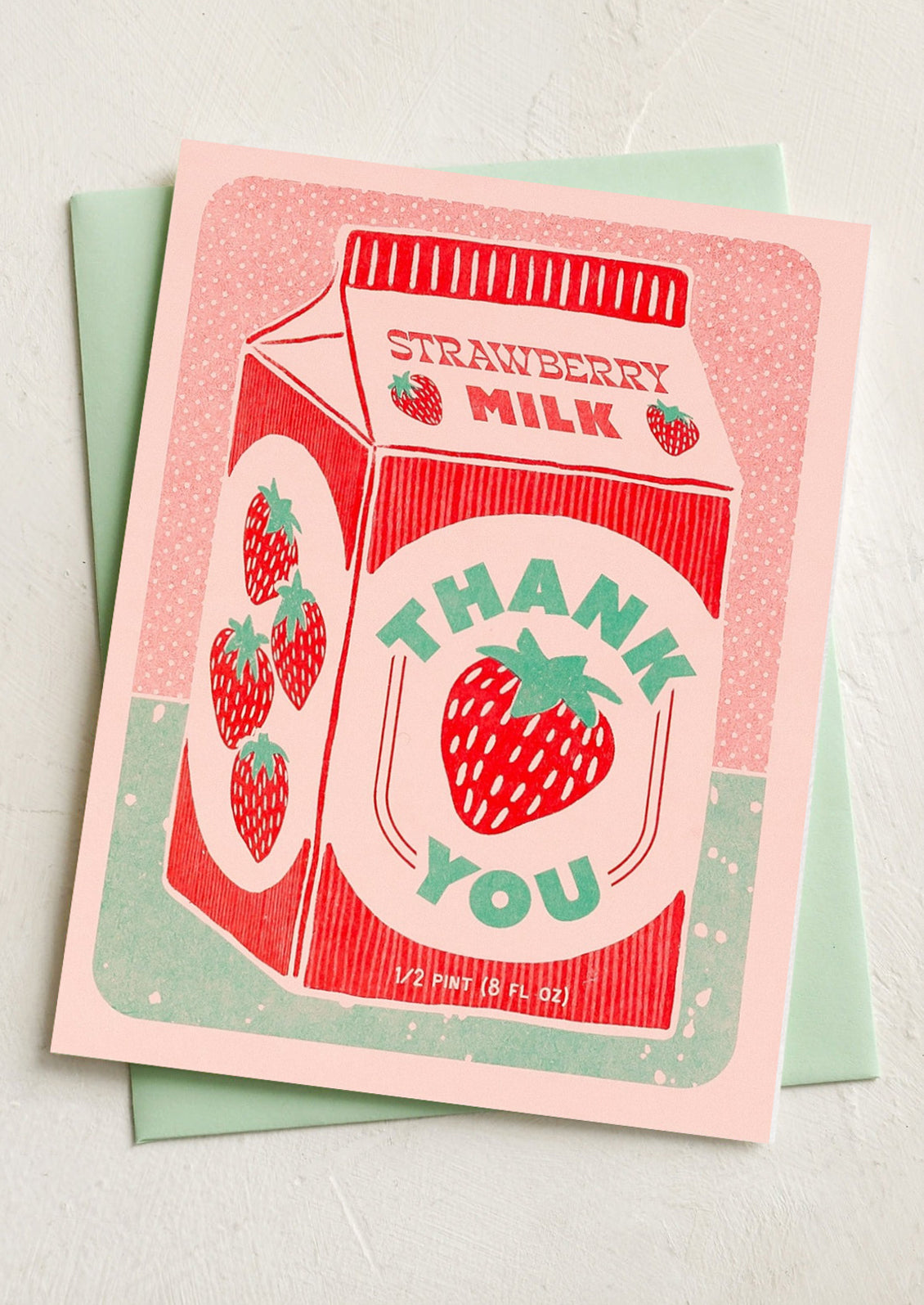 Card with strawberry milk design and 'Thank you' text on a light background