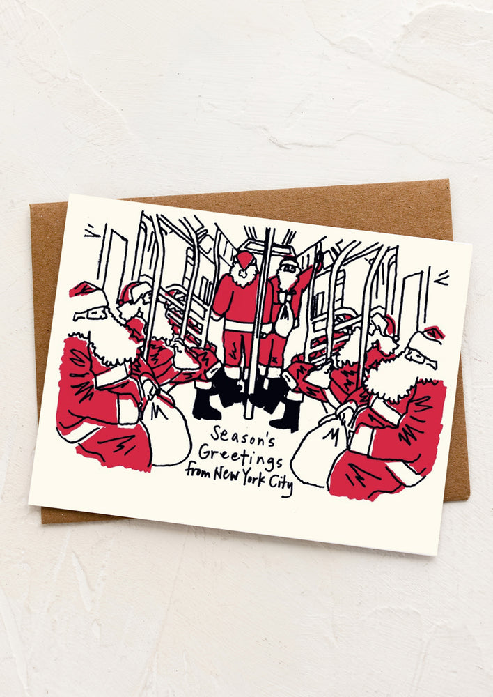 An illustrated card with Santas riding the subway, text reads "Season's Greetings From New York City".