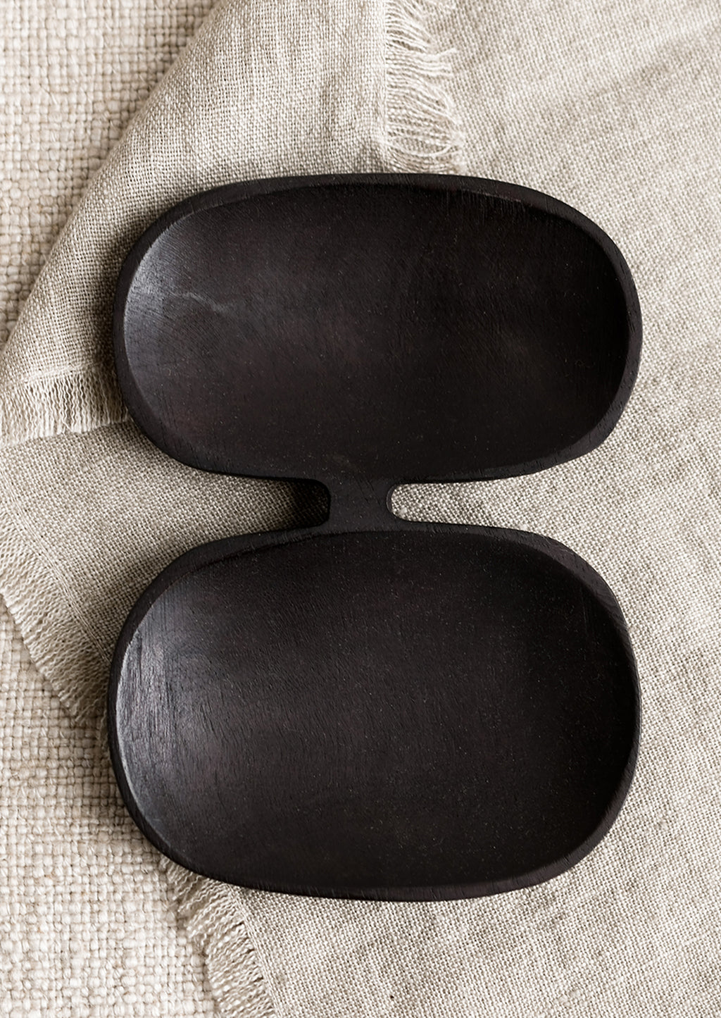 Large: A double wide wooden dish with mirrored oval shape in blackened wood.