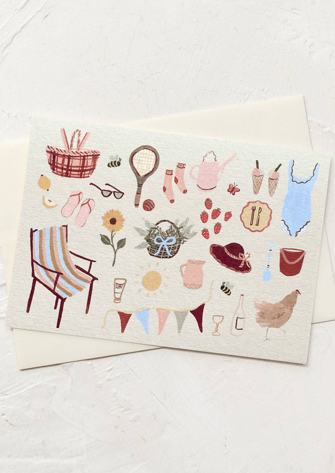 A greeting card with illustration of playful summer things like flowers, ice cream, and a bathing suit.