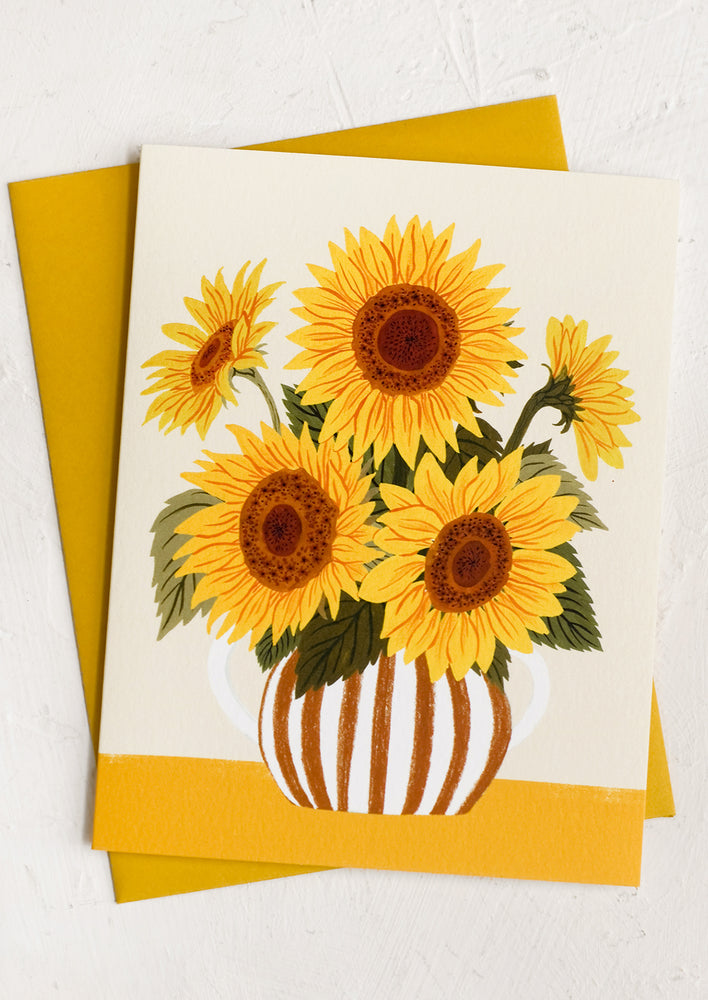 A greeting card with illustration of sunflowers in a striped vase.
