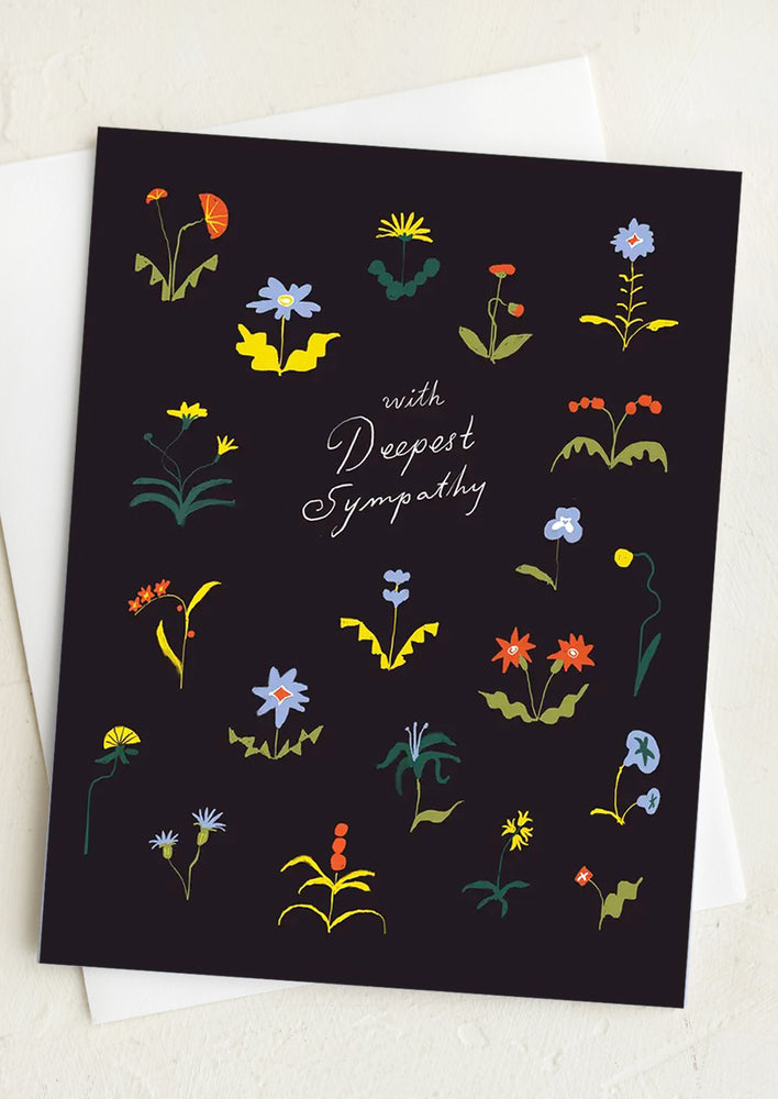 1: A black floral print greeting card reading "With deepest sympathy".