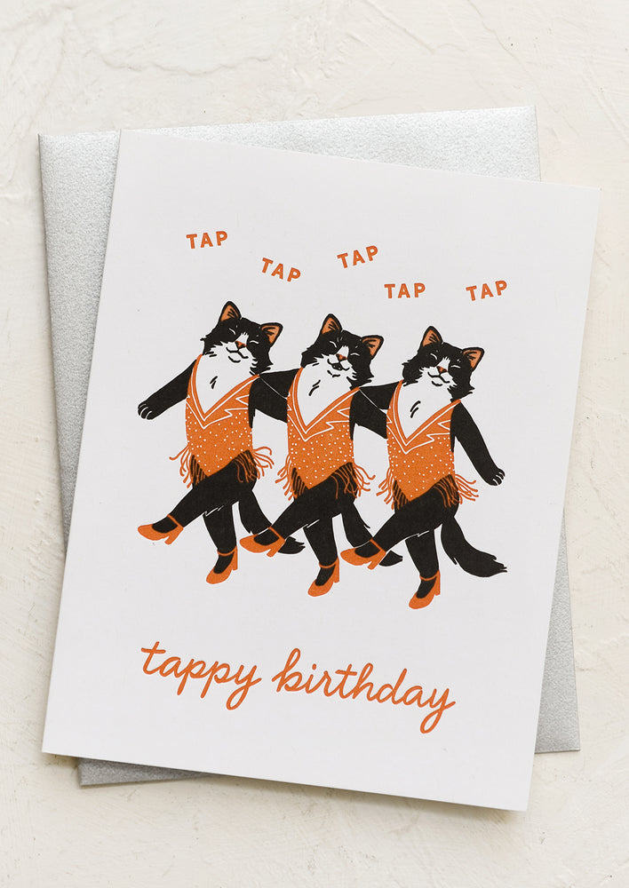 A card with illustration of cats as tap dancers, text reads "Tappy birthday".