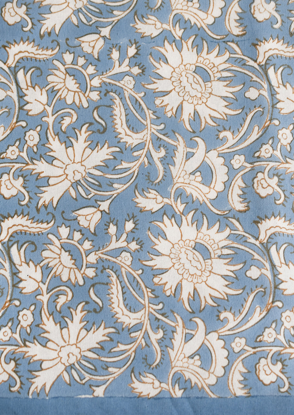 French Blue / Brown: A block print tablecloth in sky blue with white and brown floral print.