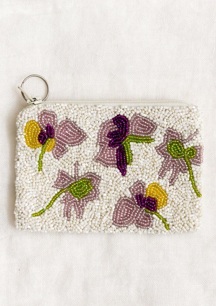 1: A beaded coin pouch with green, purple and yellow floral design.