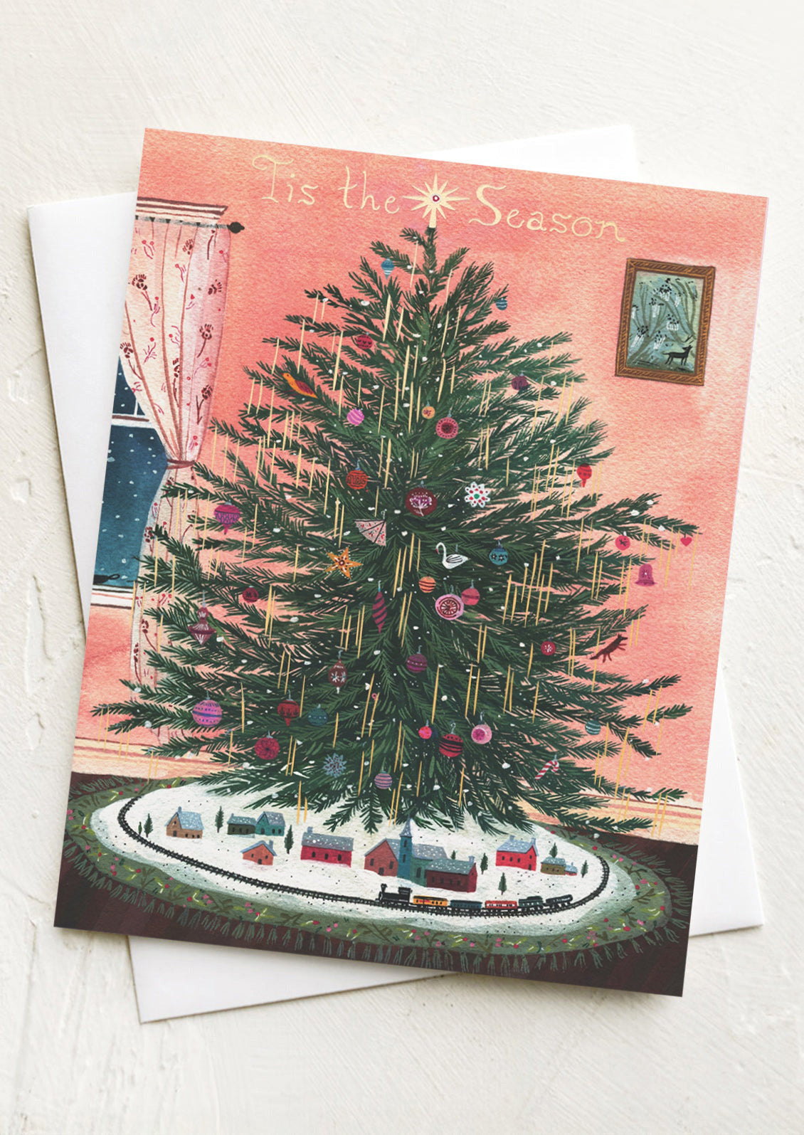 Christmas card with a decorated Christmas tree and 'Tis the Season text on a pink background.