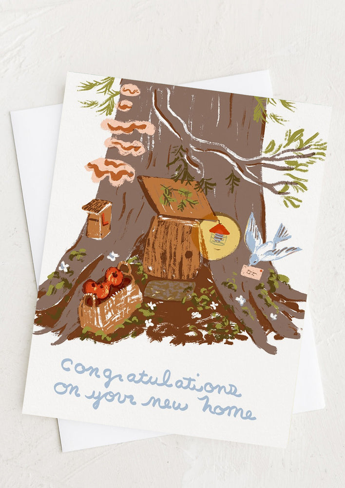 1: A greeting card with illustration of home in the bottom of a tree.