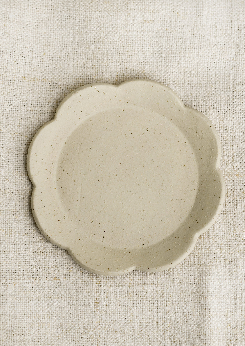 Alabaster: A floral shaped trinket dish in cream.