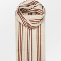 2: A cream cotton scarf with vertical brown stripe pattern.