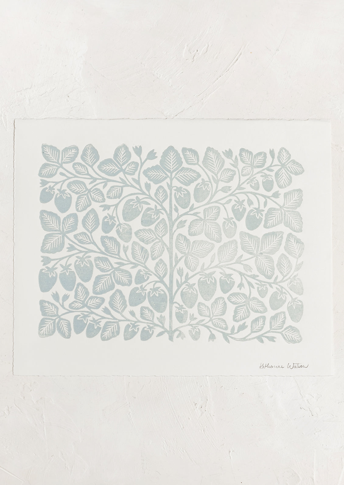 An ivory deckled edge paper with woodcut strawberry print in blue ink.