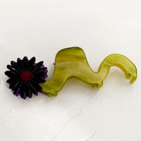 Purple Multi: A wavy green hair claw with purple flower.