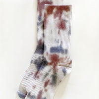 Western: A pair of tie dye socks in white with maroon and blue.