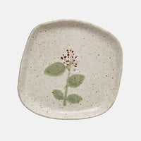 Wide Red Flower: Ceramic plates in asymmetrical shapes with wildflower patterns.