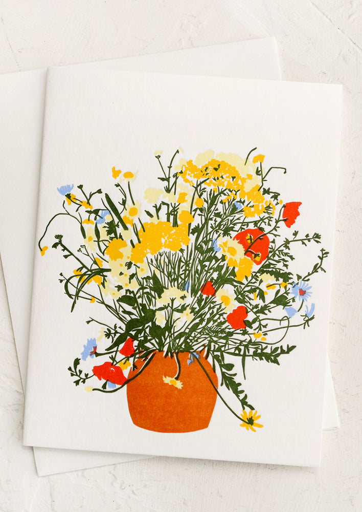 1: A letterpressed greeting card with image of colorful floral arrangement.