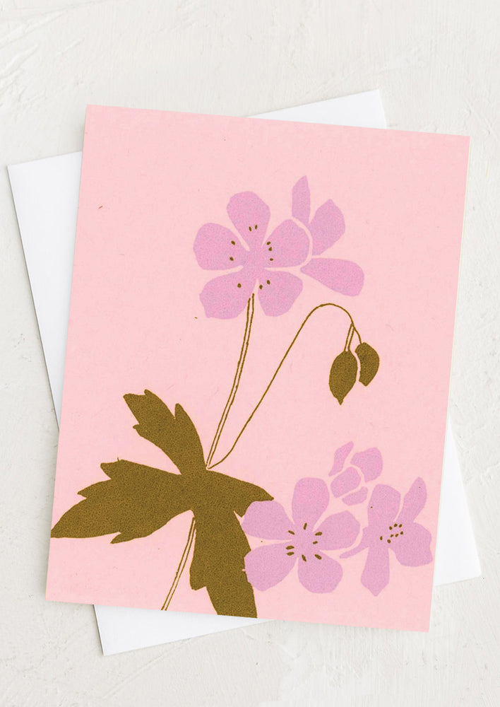 A pink greeting card with silk screen printed geranium design.