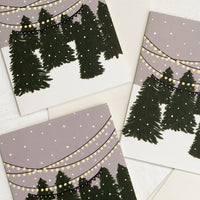 1: A set of holiday greeting cards with illustration of Christmas tree lot, text reads "Season's greetings".