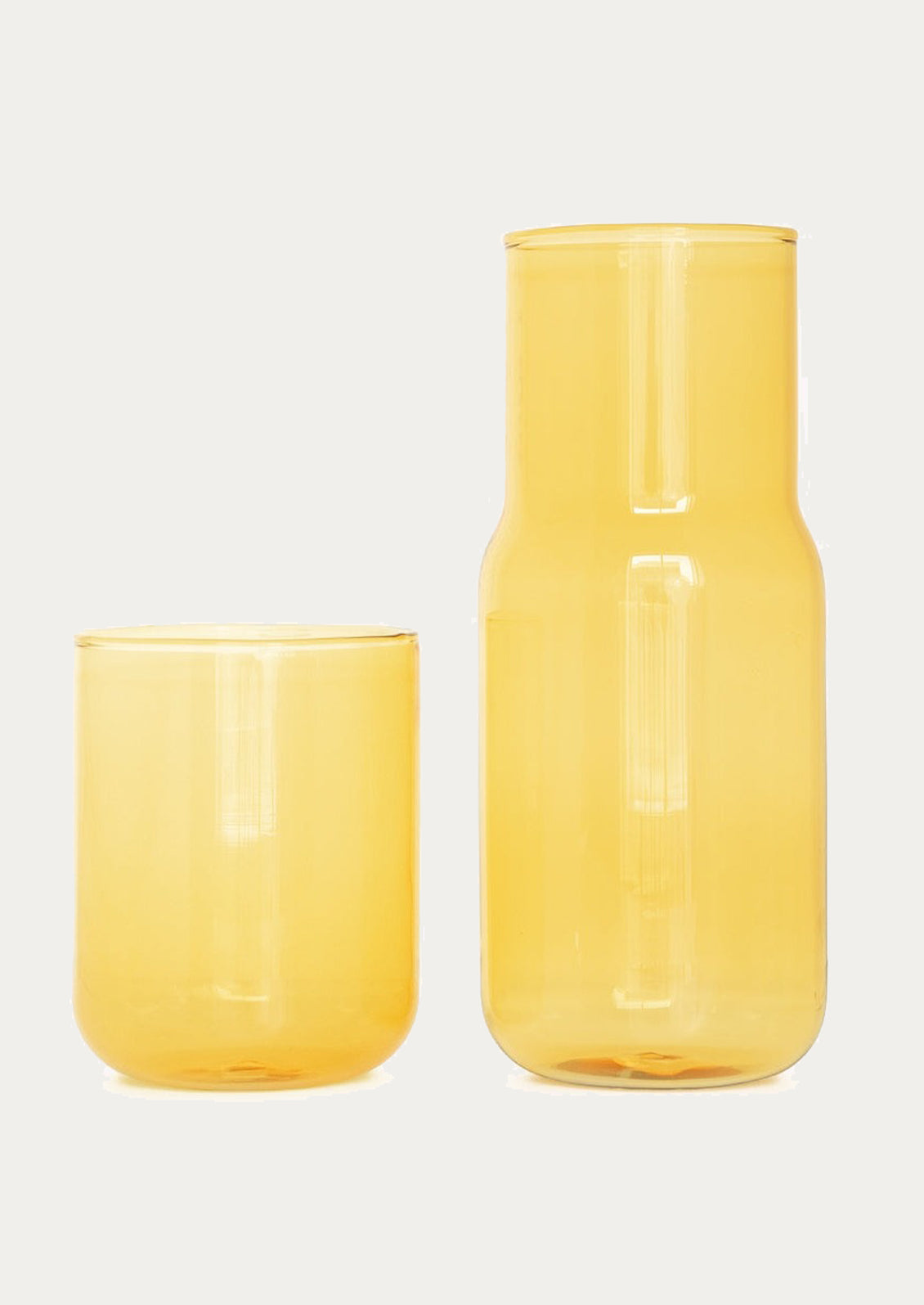 A stackable carafe and cup in transparent yellow color.