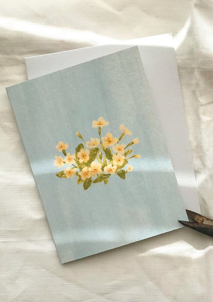 A blue card with yellow flowers.