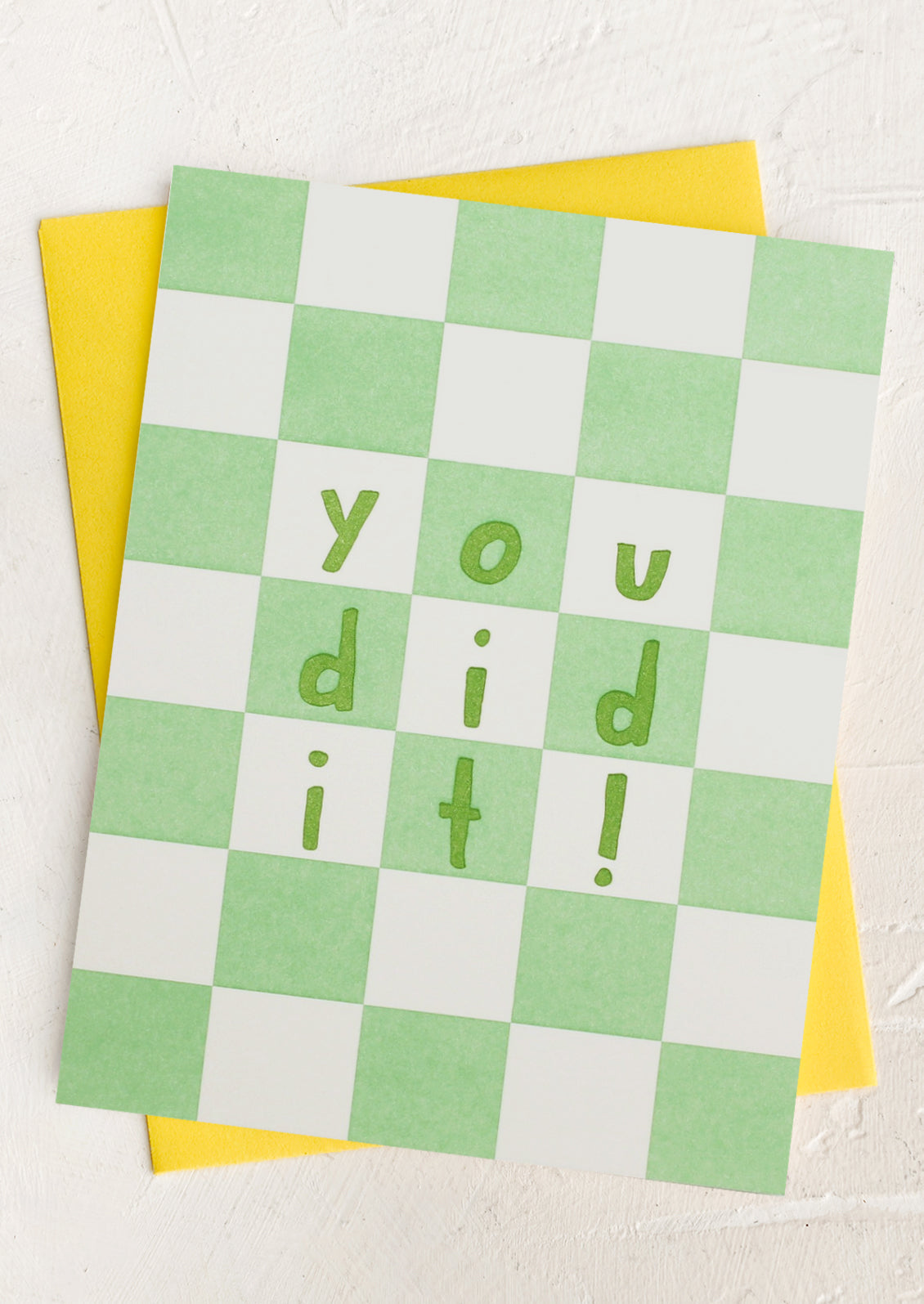 A green checker print card with text reading "You did it!".