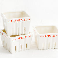 2: Ceramic berry baskets made to look like the disposable variety, but in white ceramic with red letters in French.