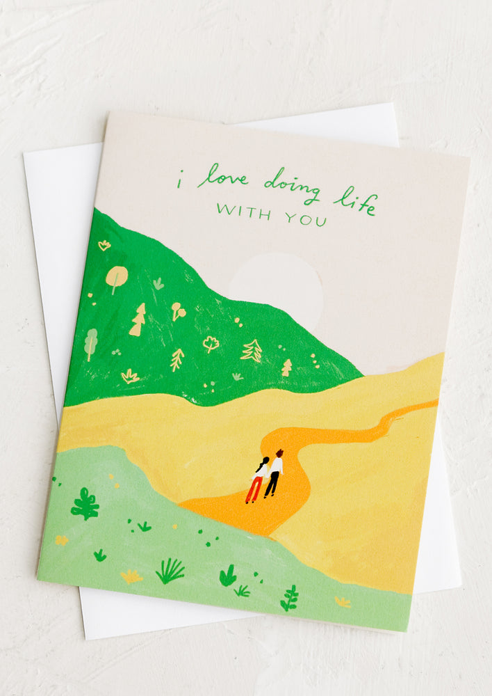 1: A card with illustration of two people hiking, card reads "I love doing life with you".